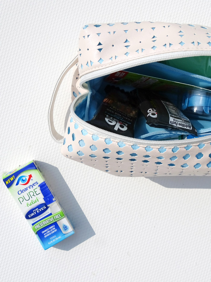 Top view of Clear Eyes package next to partial view of cosmetic bag filled with other boating essentials.