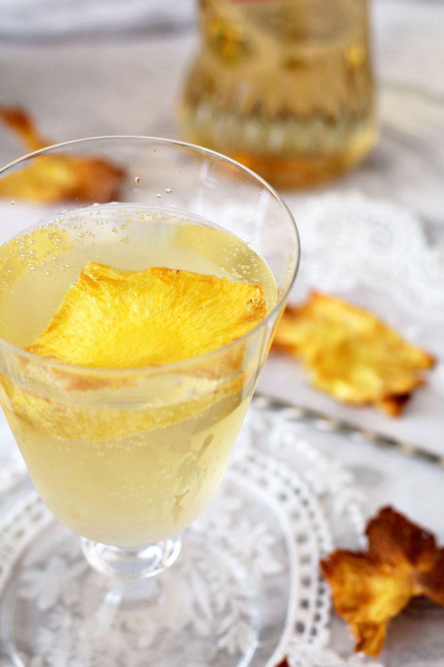 Passion Fruit Pineapple Spritz topped with pineapple flower garnish.