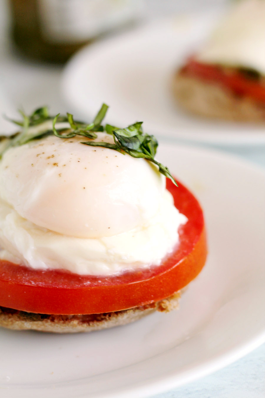 Close up of Poached Eggs Caprese on a plate.