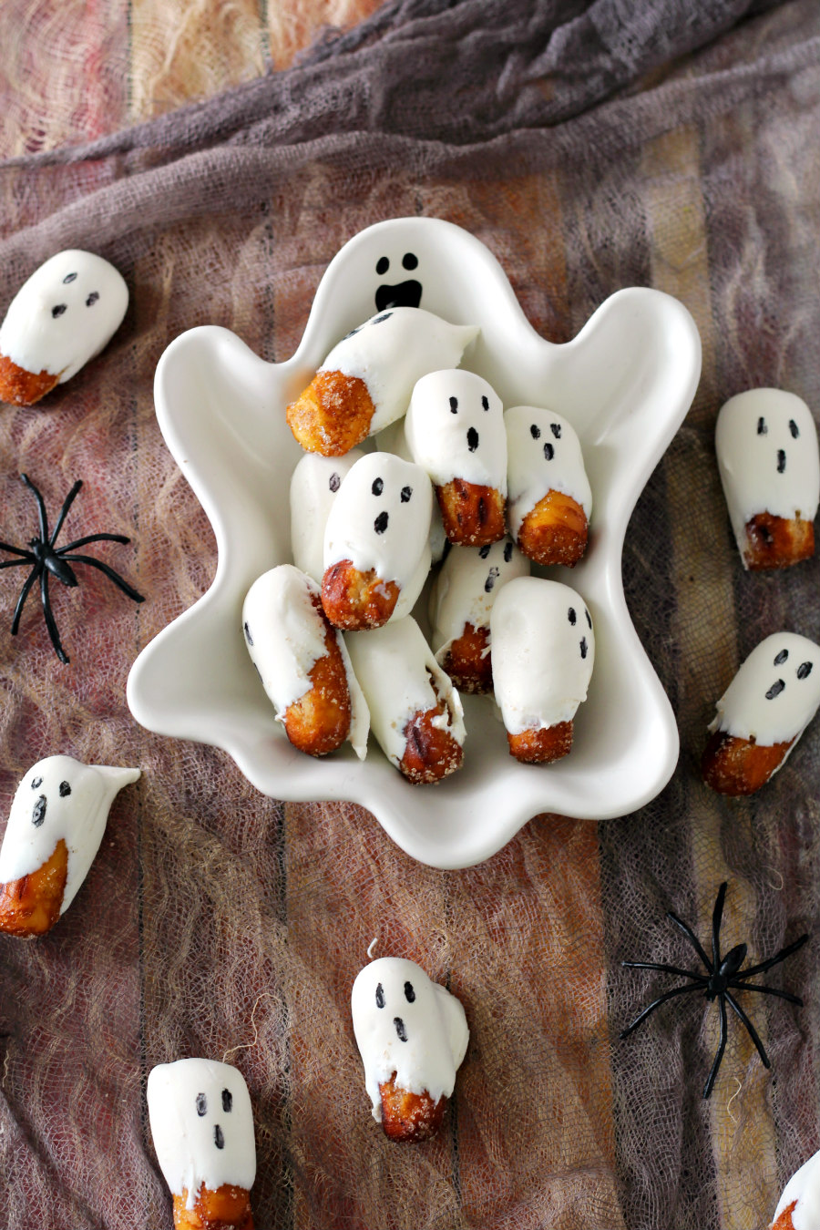 Flat lay photo of ghost shaped bowl full of Halloween Ghost Pretzel Nuggets.