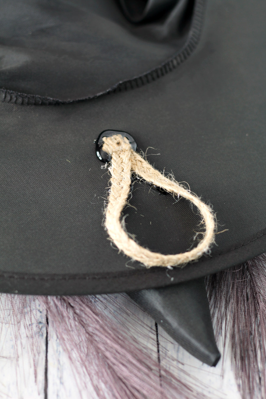 Jute ribbon loop hot glued onto back of witch hat.