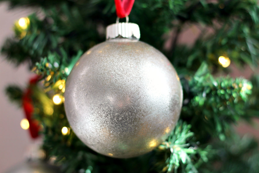 Horizontal photo of DIY Vintage Mercury Glass Ornament hanging on Christmas tree.