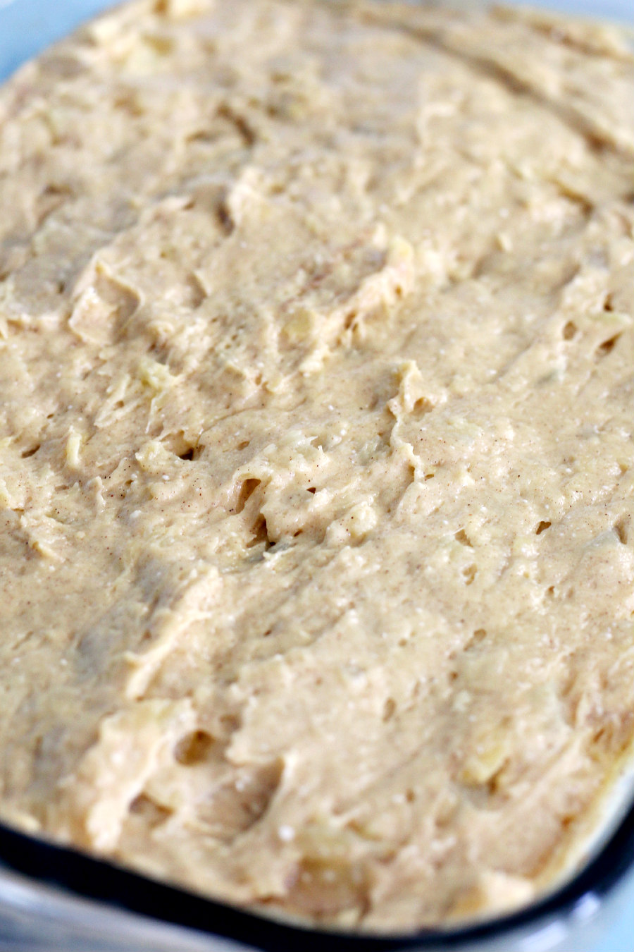 Close up photo of Hummingbird Pudding Dump Cake batter in glass baking pan.