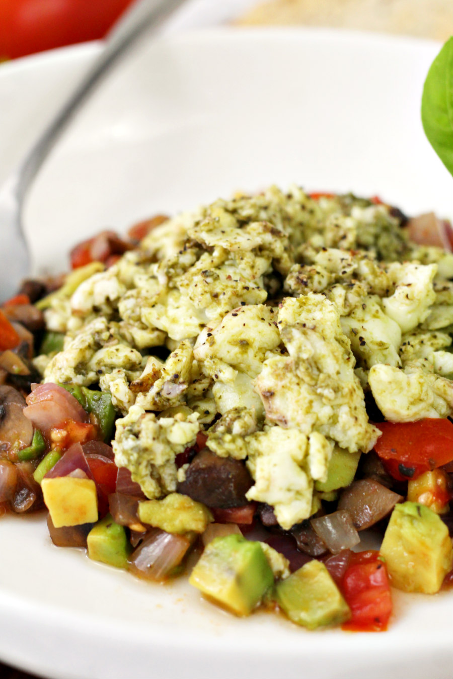 Close up photo of Pesto Infused Egg White Skillet served in white plate.  Silver fork can be seen in background.  