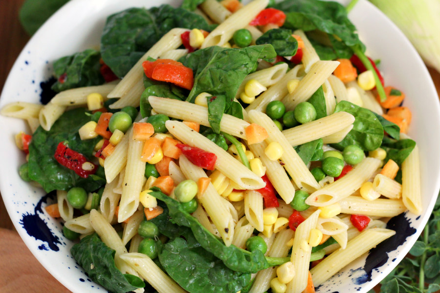 Horizontal view of Vegetable Penne Pasta Salad in serving dish.